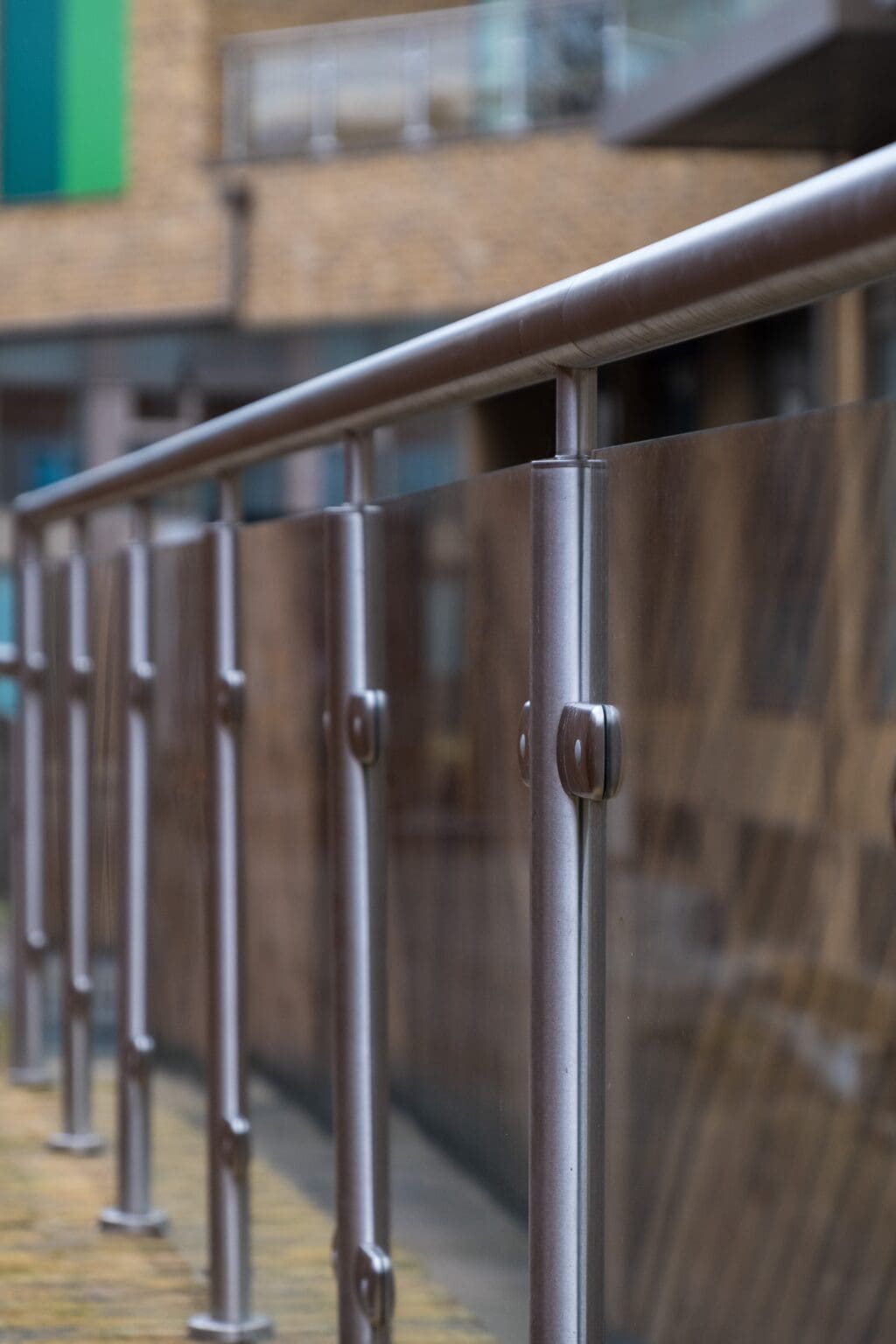 Close-up of aluminium top rail on Neaco Clearview balcony, featuring toughened glass panels