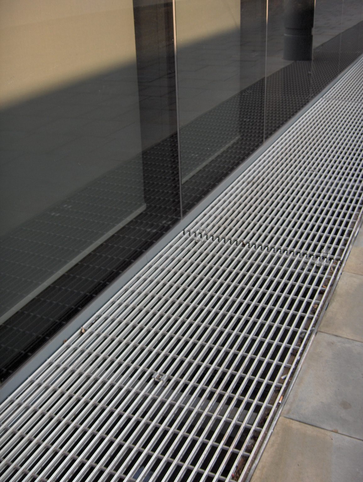 Close-up of NI Bar ventilation grille with ribbed surface for enhanced non-slip properties, installed along the front elevation of an office building at Brewery Wharf, Leeds.