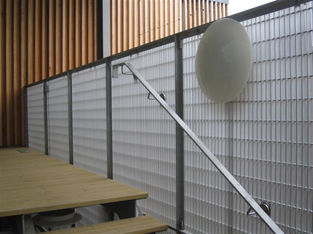 Close-up of Neaco's Flat Bar aluminium modular grating system installed as a balustrade infill at the Royal Shakespeare Company’s Chapel Lane facility in Stratford Upon Avon.