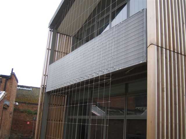 Detailed view of the Flat Bar aluminium grating system in use as a railing and privacy screen at the Royal Shakespeare Company’s Chapel Lane premises.