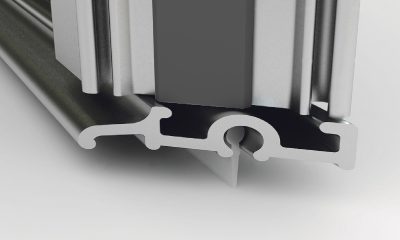 Offset doors containing aluminium section water deflectors and round sleeve wiper blades to retain water within the showering area.